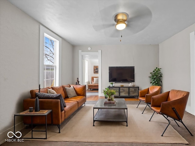 living room with light wood-type flooring and ceiling fan