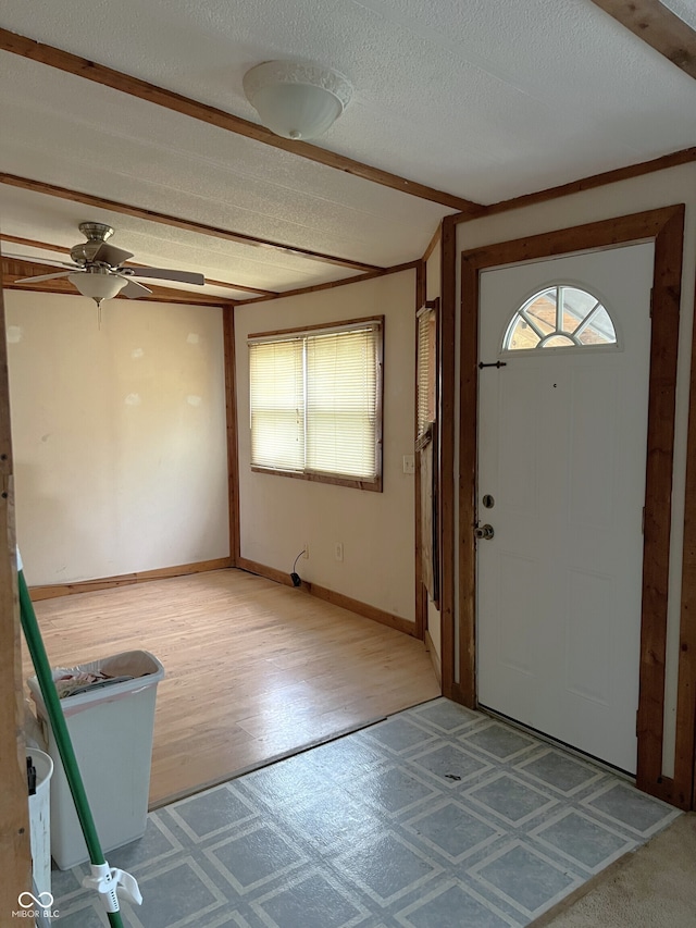 entryway featuring wood-type flooring, a textured ceiling, and ceiling fan