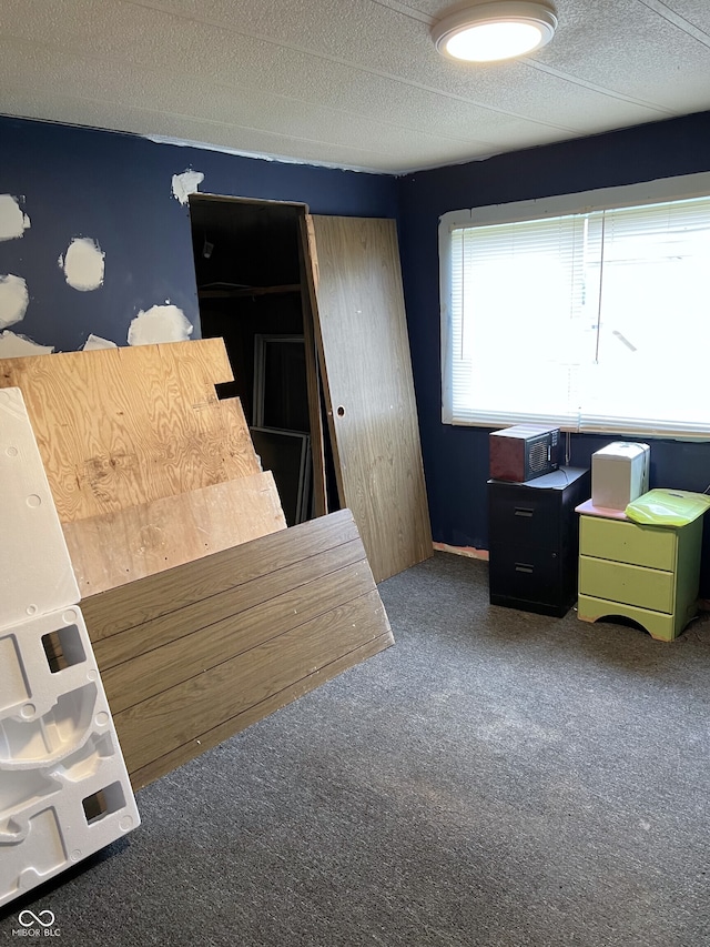 bedroom with carpet floors and a textured ceiling