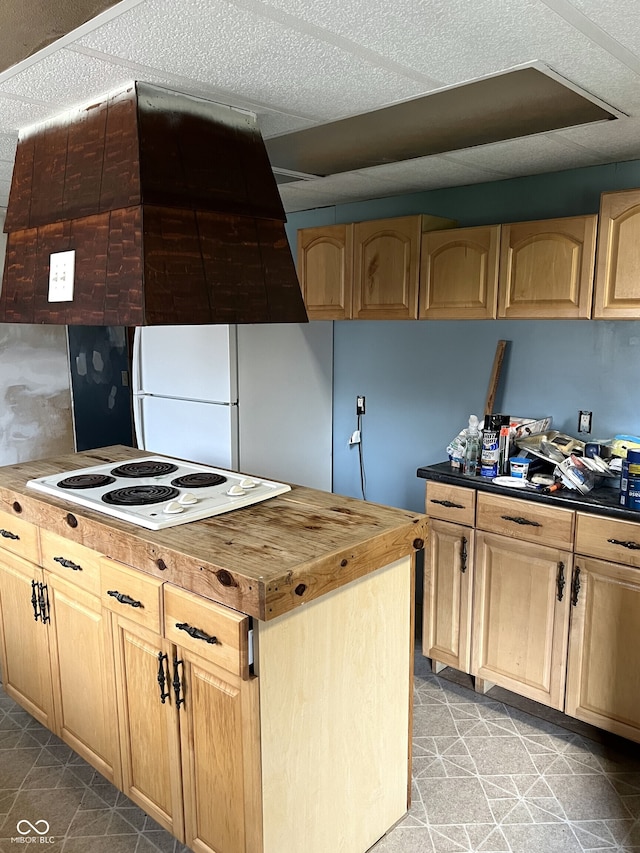 kitchen with light brown cabinetry and white appliances