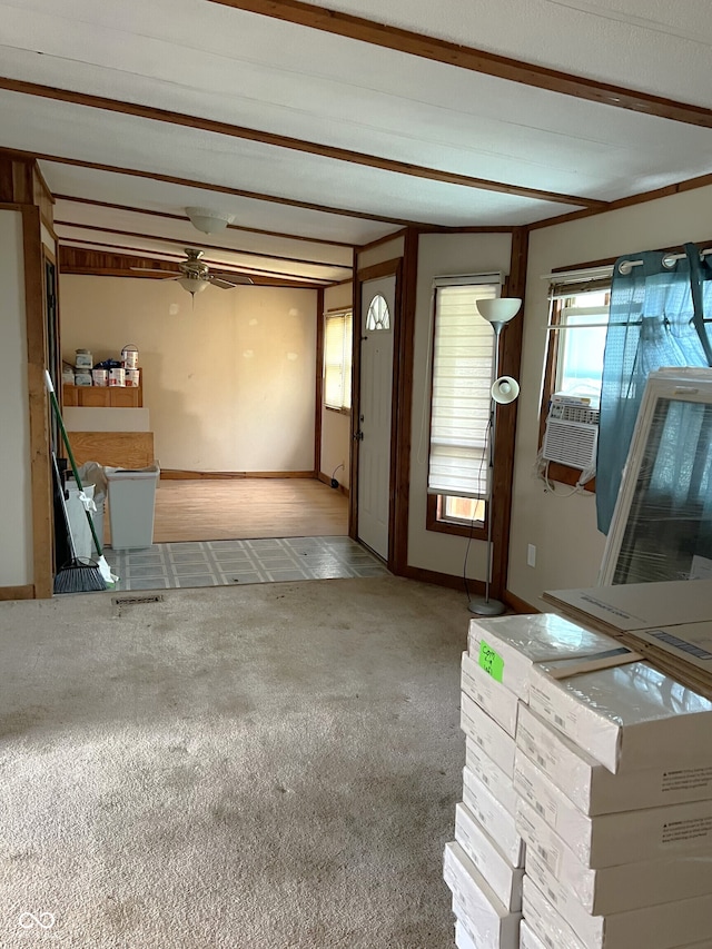 interior space with ceiling fan, cooling unit, and beam ceiling