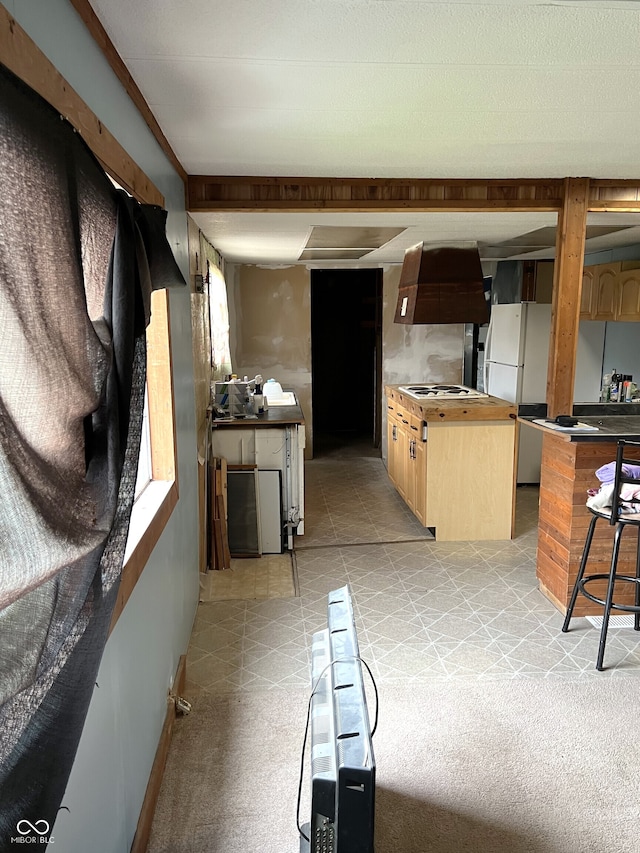 kitchen featuring light colored carpet, white appliances, and light brown cabinetry