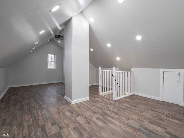 bonus room featuring dark wood-type flooring and vaulted ceiling