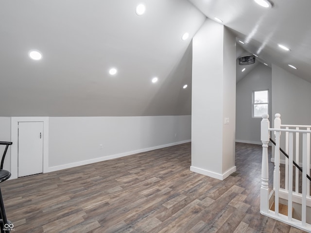 additional living space featuring dark hardwood / wood-style floors and lofted ceiling