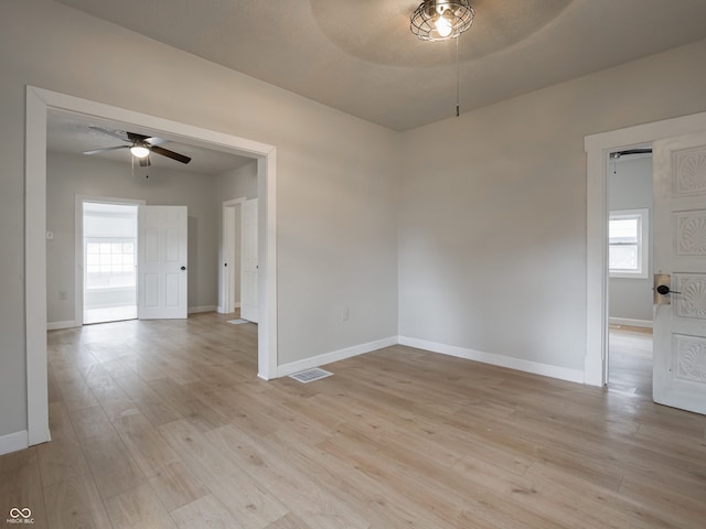 unfurnished room with ceiling fan and light hardwood / wood-style floors