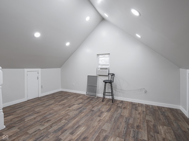 bonus room with cooling unit, dark wood-type flooring, and vaulted ceiling