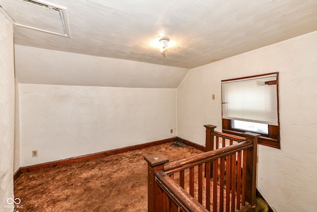 additional living space featuring carpet flooring and lofted ceiling