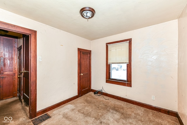 unfurnished room with carpet flooring