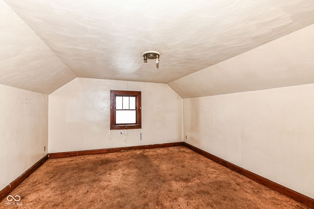 additional living space with carpet and vaulted ceiling