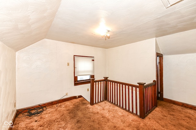 additional living space featuring light carpet and lofted ceiling