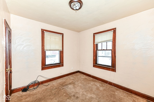 unfurnished room featuring carpet