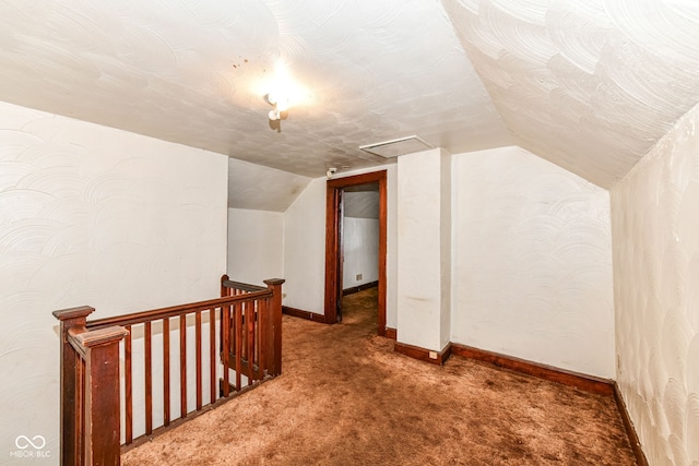 bonus room with carpet floors and vaulted ceiling