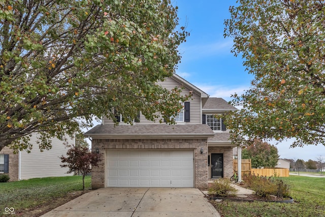 view of front of property featuring a garage and a front lawn