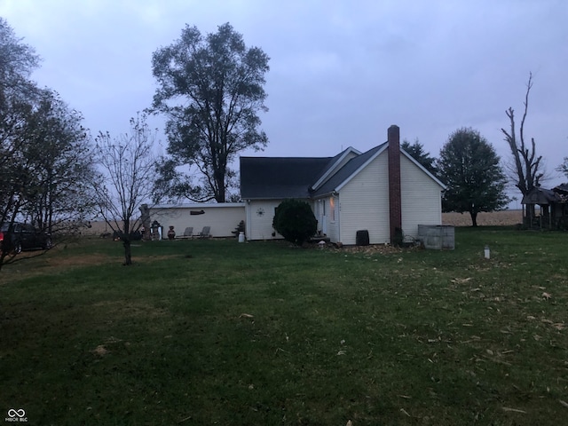 view of side of home with a lawn