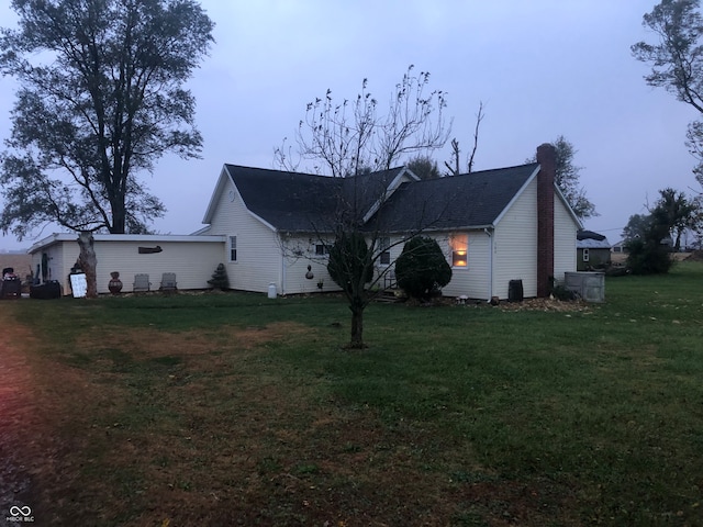 view of side of property with a yard