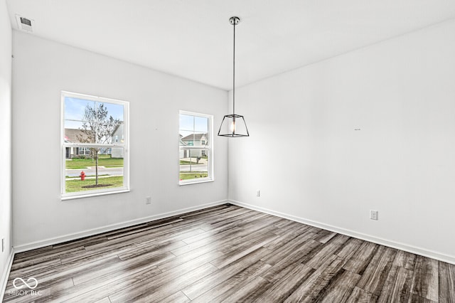 unfurnished dining area featuring wood-type flooring