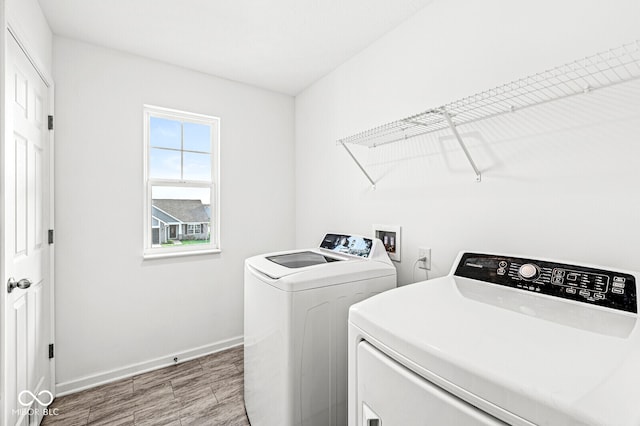 washroom with wood-type flooring and washer and clothes dryer