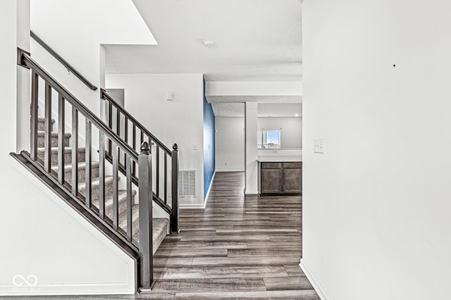 staircase featuring wood-type flooring