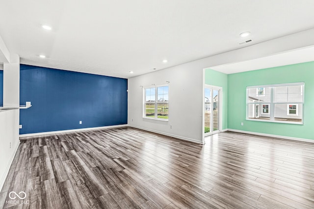 unfurnished living room with wood-type flooring