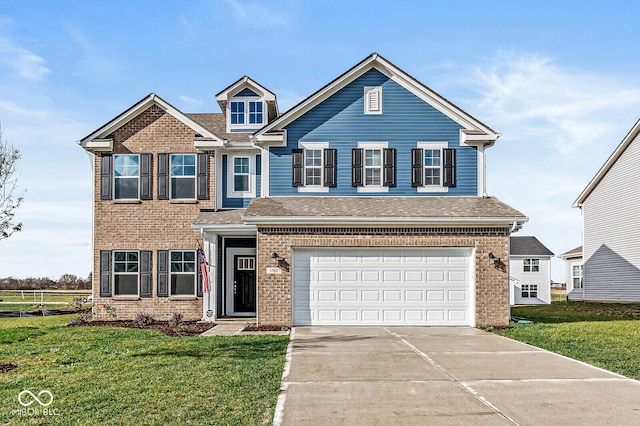 view of front of home with a front yard and a garage