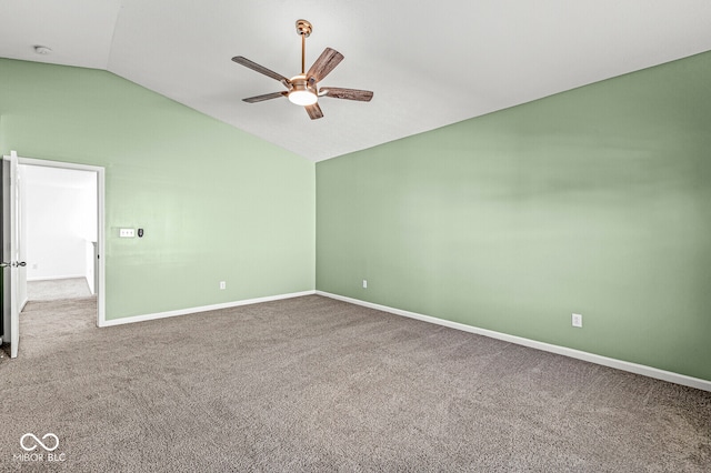 carpeted spare room featuring ceiling fan and vaulted ceiling