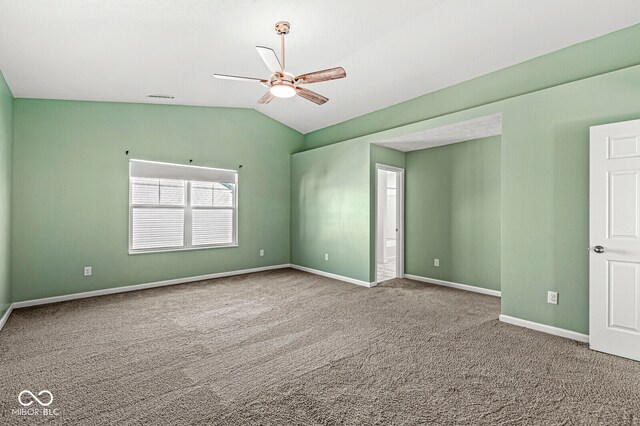 carpeted empty room with ceiling fan and lofted ceiling