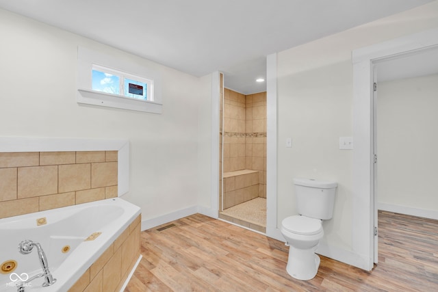 bathroom featuring toilet, independent shower and bath, and hardwood / wood-style flooring