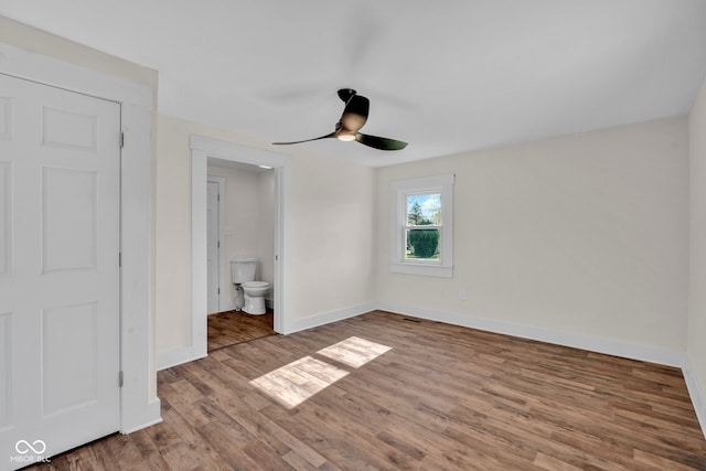 unfurnished bedroom with connected bathroom, ceiling fan, and light wood-type flooring