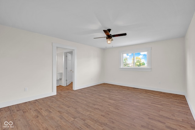 spare room with ceiling fan and light wood-type flooring