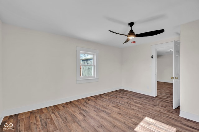 empty room featuring wood-type flooring and ceiling fan