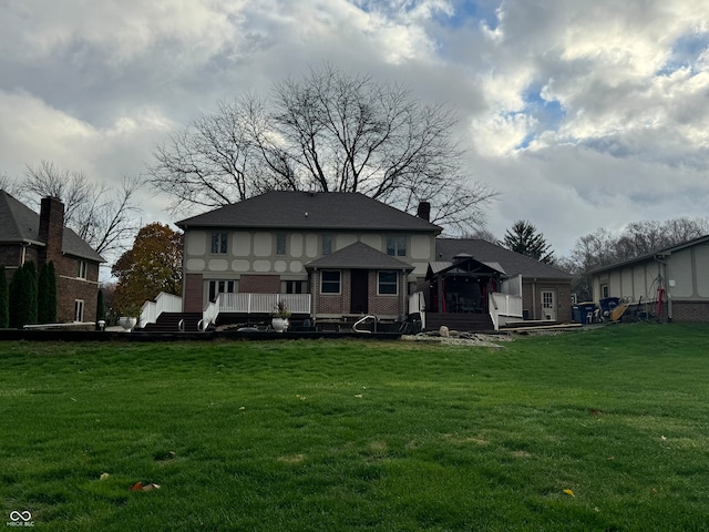 rear view of house featuring a gazebo and a yard