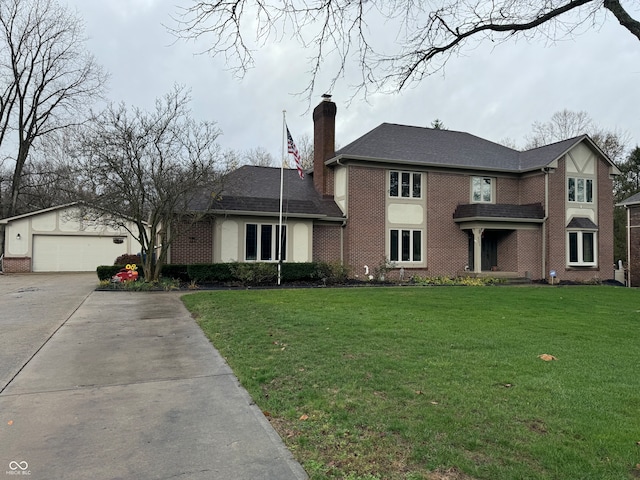 view of front facade with a garage, an outbuilding, and a front lawn