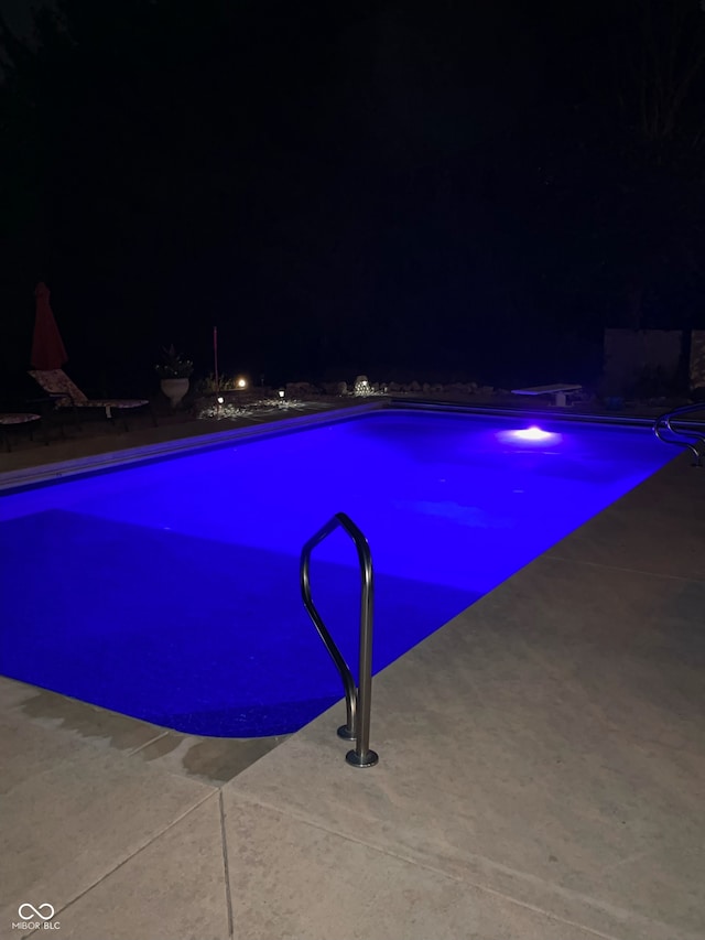 view of pool at night