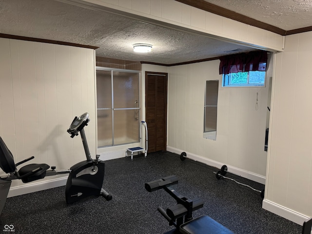 exercise area with ornamental molding and a textured ceiling