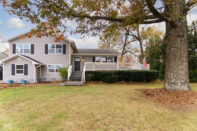 tri-level home with a deck and a front lawn