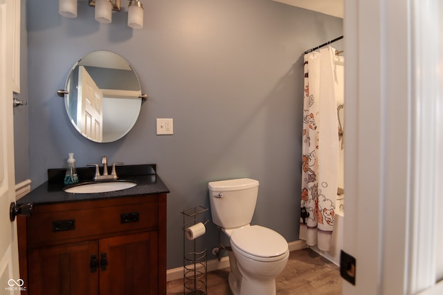 full bathroom featuring hardwood / wood-style floors, vanity, toilet, and shower / bath combo with shower curtain