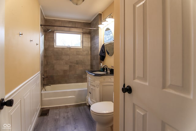 full bathroom with hardwood / wood-style flooring, vanity, toilet, and tiled shower / bath combo