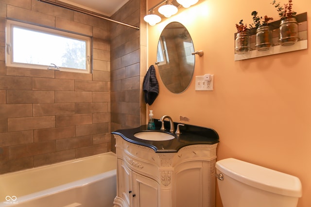 full bathroom with vanity, tiled shower / bath combo, and toilet