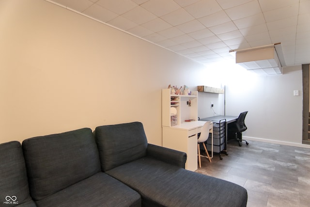 living room featuring a drop ceiling