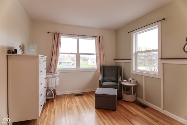 sitting room featuring light hardwood / wood-style floors