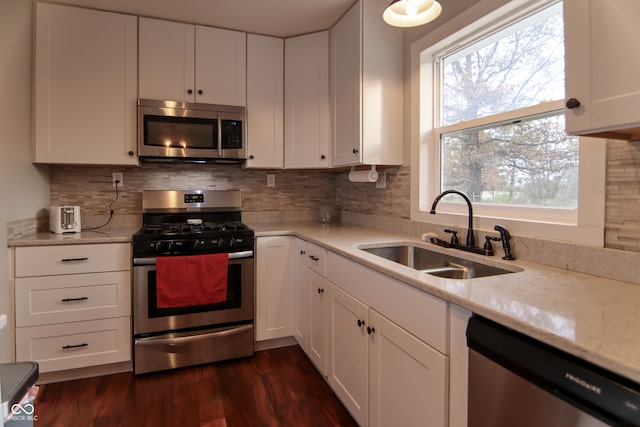 kitchen featuring a wealth of natural light, white cabinetry, sink, and stainless steel appliances