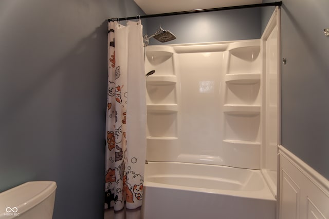 bathroom featuring shower / bath combo and toilet