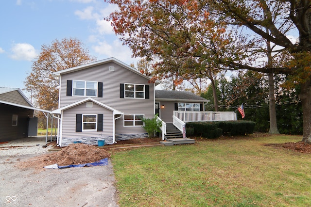 view of front of property featuring a carport and a front lawn