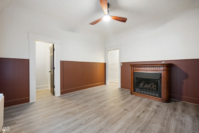 unfurnished living room featuring ceiling fan and light hardwood / wood-style flooring