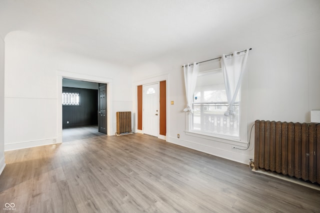 unfurnished room with hardwood / wood-style floors and radiator