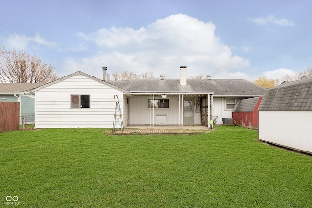 back of property featuring a shed and a lawn