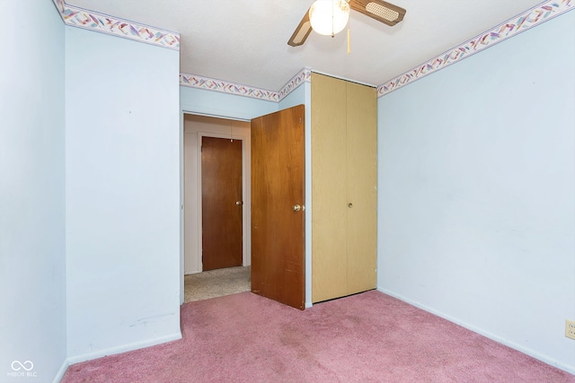 unfurnished bedroom featuring carpet, ceiling fan, and a closet