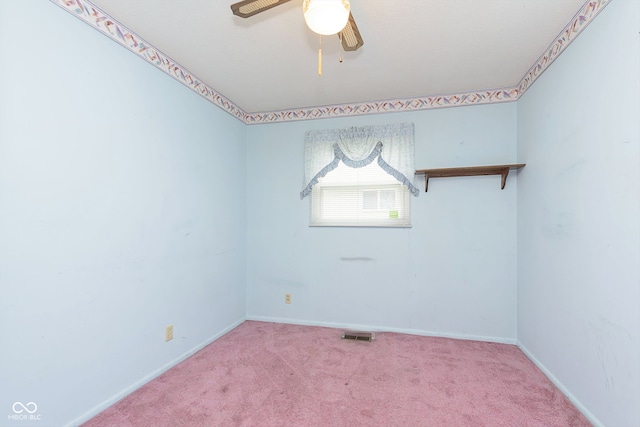 empty room featuring carpet floors and ceiling fan