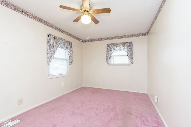 carpeted spare room with ceiling fan and crown molding