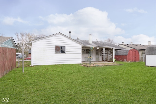 rear view of house featuring a patio area, a shed, and a yard